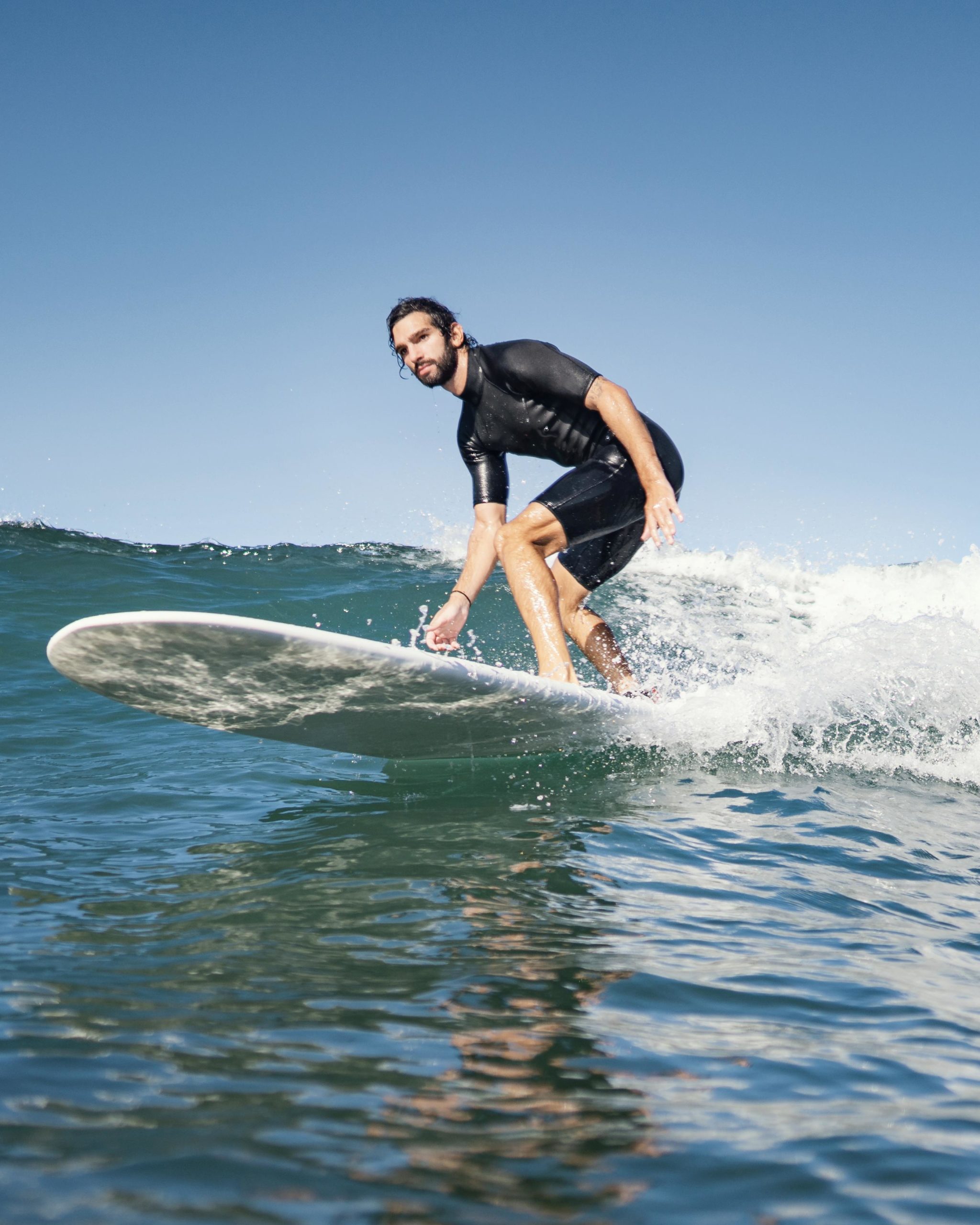 2024/02/man-riding-his-surfboard-having-good-time-scaled.jpg