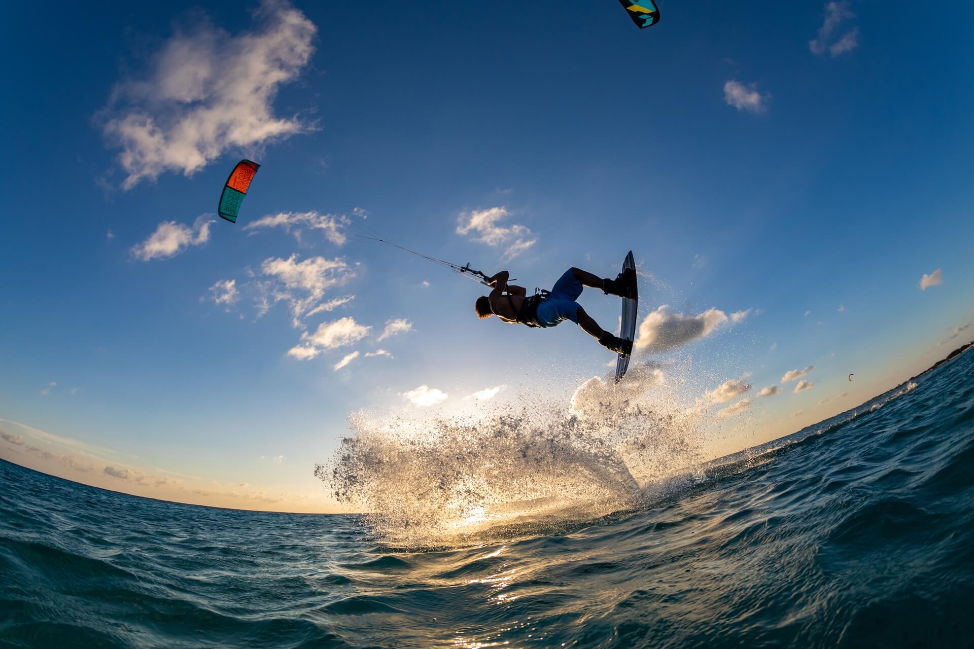 2024/02/person-surfing-flying-parachute-same-time-kitesurfing-bonaire-caribbean.jpg