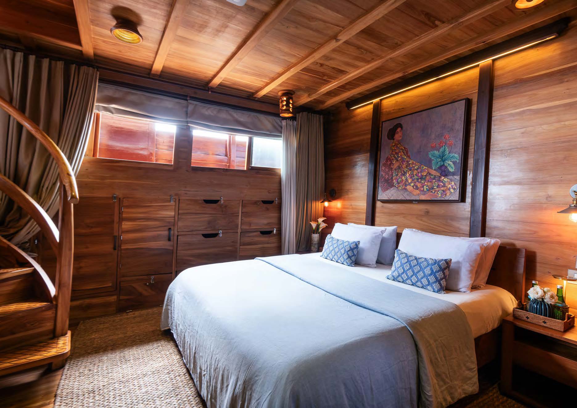 Island Suite interior on Sequoia yacht with teak staircase and artwork