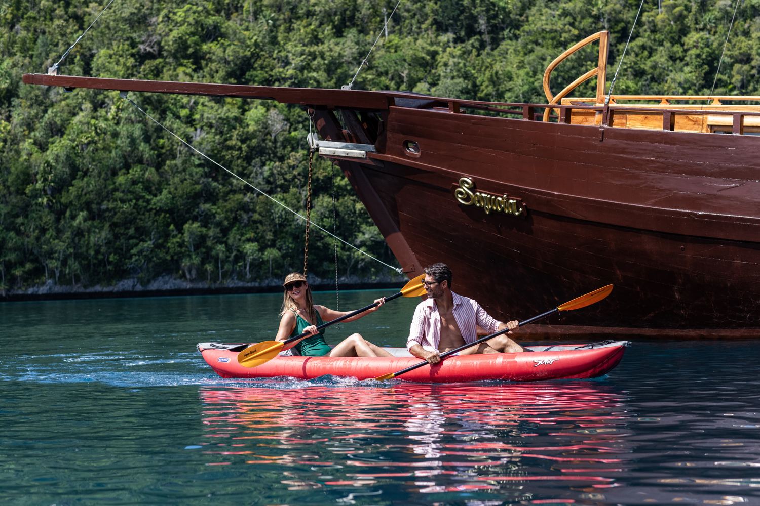 Couple kayaking beside Sequoia in a calm lagoon