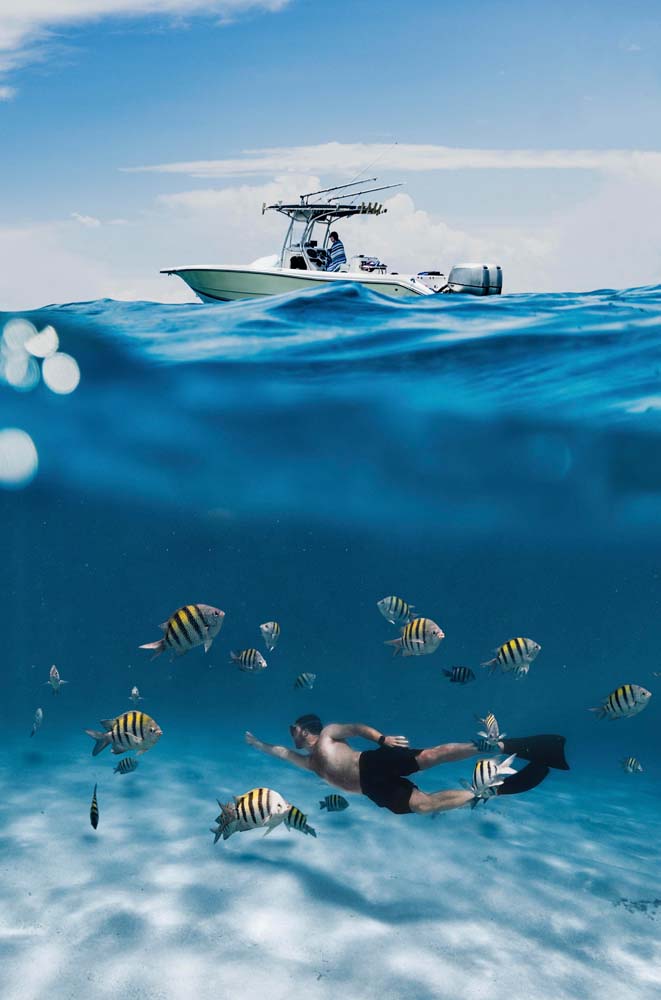 2024/04/full-shot-man-swimming-with-fish.jpg