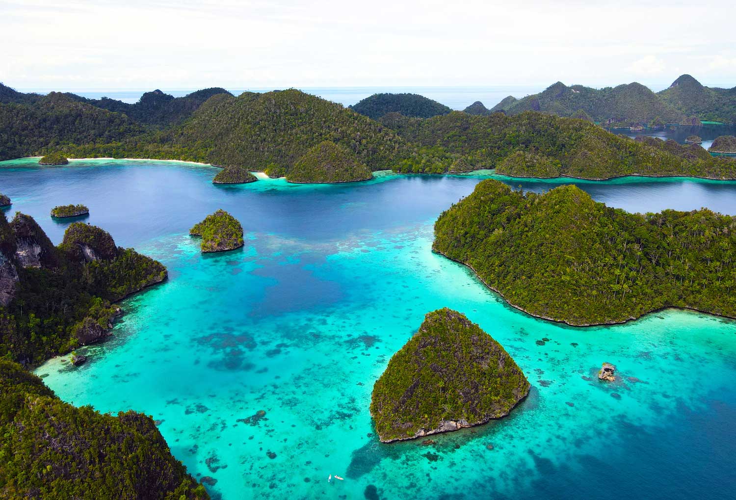 Iconic aerial shot of Raja Ampat islands, Indonesia’s top luxury travel destination for liveaboards and yacht charters.