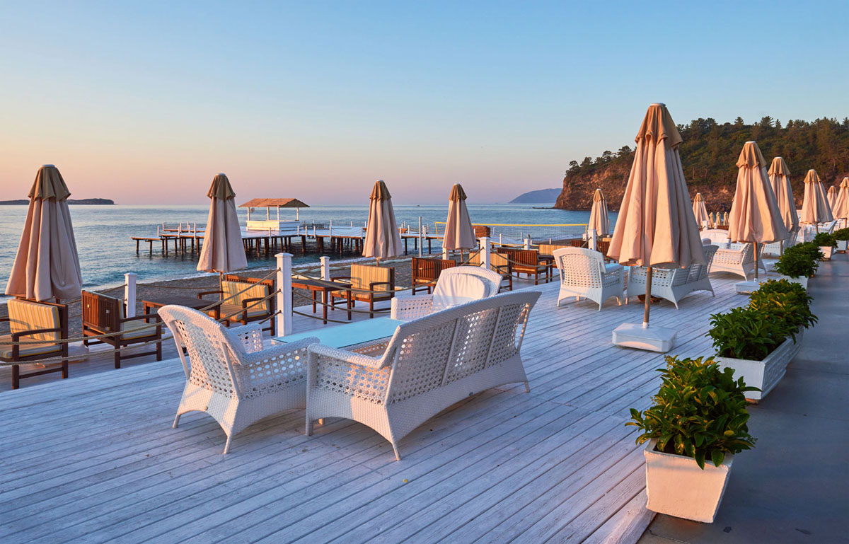Scenic beachfront resort lounge with ocean view at sunset